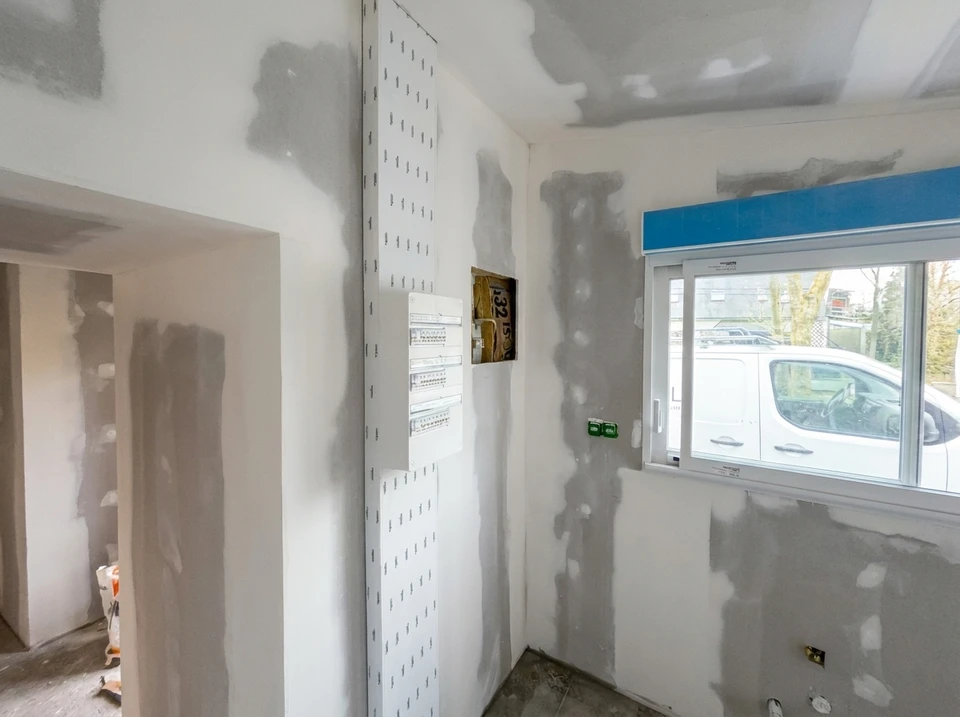 Chantier de rénovation intérieure en cours avec cloisons en plaques de plâtre partiellement installées